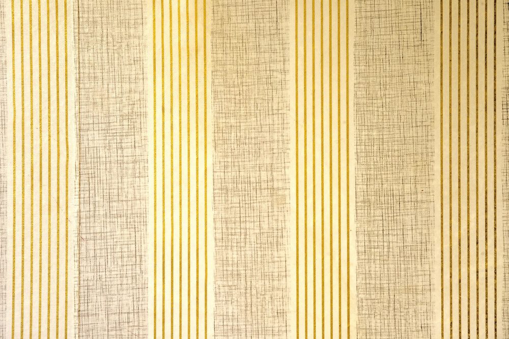 Close-up of vertical striped wallpaper with metallic pinstripes showing even, aligned seams