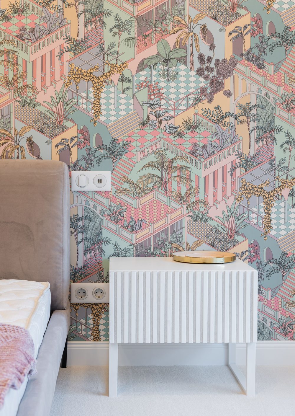 Bedroom refreshed with a soft pastel botanical mural behind a fluted nightstand